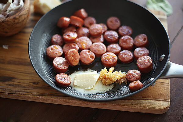 Adding butter and garlic to pan.