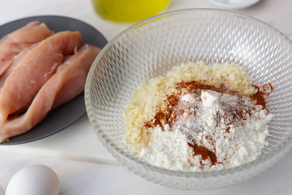 Mixing together the breading for the chicken strips.