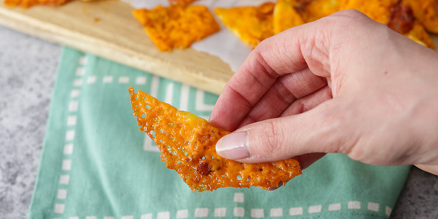 Hand holding up cheese chips