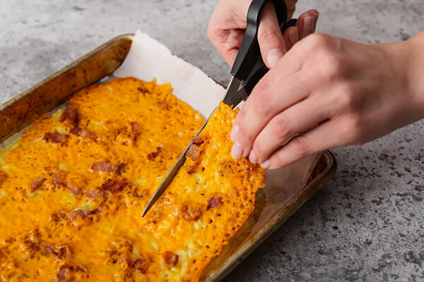 Cutting the cheese into chips.