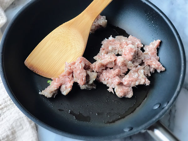 Cooking the ground sausage.